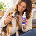 Woman using DentaPaw Spray on her beagle